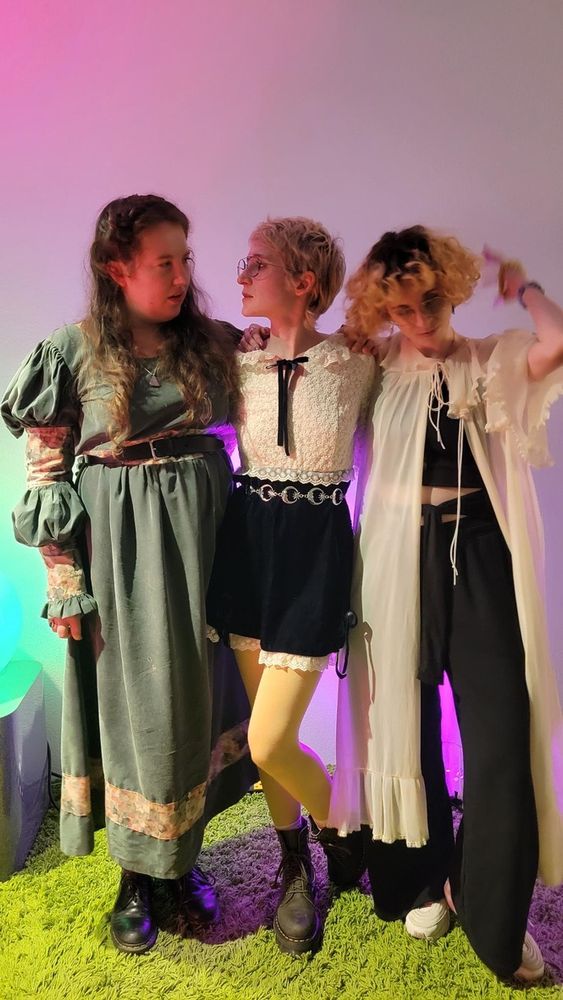 posing on the stage with annelyse and rose, the two pals who played the show with me. we're all wearing flowy whimsical outfits—not matching, but vaguely coordinated—and none of us are actually looking at the camera