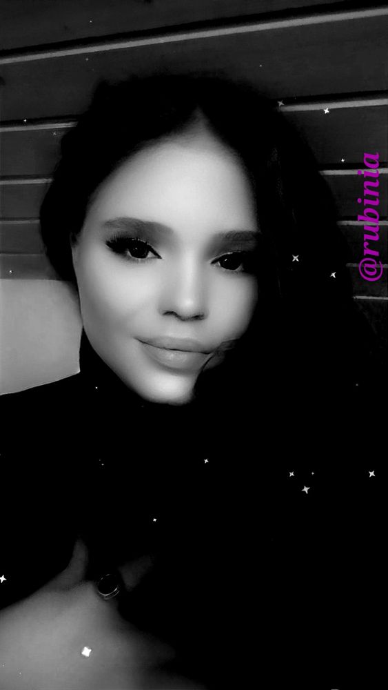 A photo of a woman, taken with black & white color, with starlight effects added in