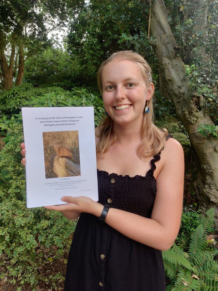 Lucy Westover holding her Masters thesis.