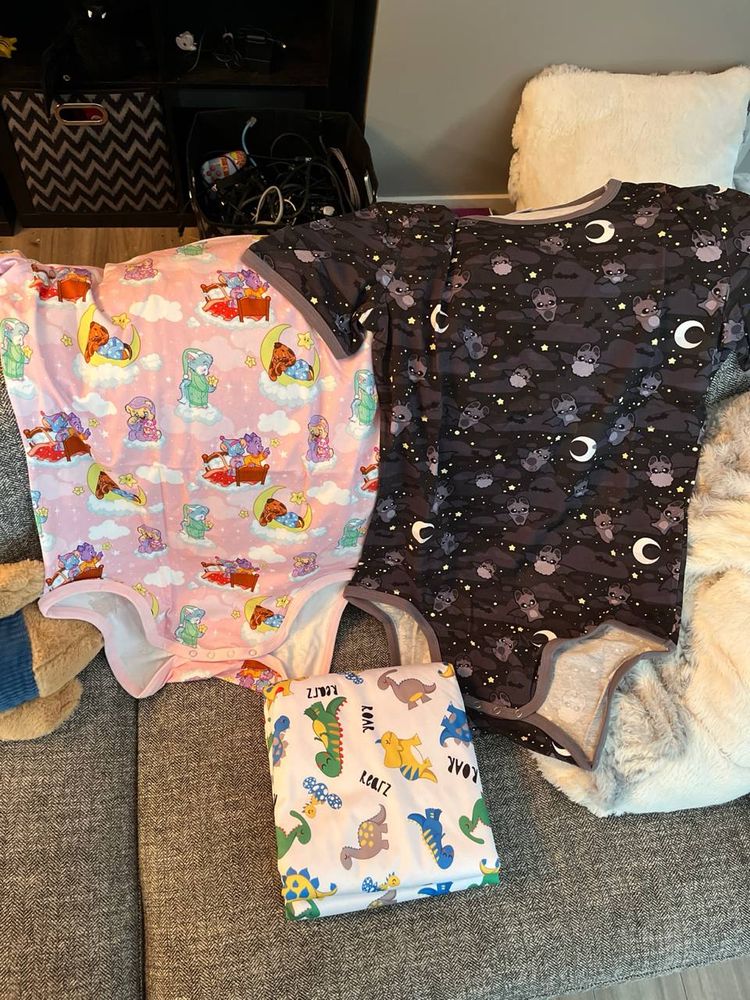 Two ODU onesies. One I think is called daydream or something, the other is batty for you. Also a rearz dino changing mat!