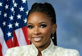 Photo of Jasmine Crockett in front of American flag 