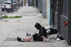 Homeless man sleeping on the sidewalk 