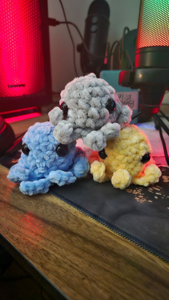 3 crocheted mini octopie blue, grey, and yellow