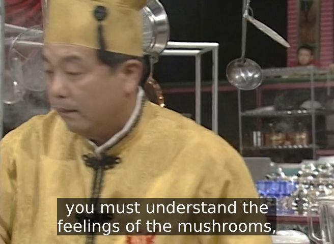 Screencap from the original Iron Chef TV show. Iron Chef Chen Kenichi stands in Kitchen Stadium, looking left with a serious expression on his face. Caption: "you must understand the feelings of the mushrooms"