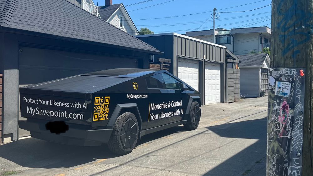 A black tactical outfitted cybertruck with branding for mysavepoint.com with QR codes and taglines protect your likeness with AI and monetize and control your likeness with AI 