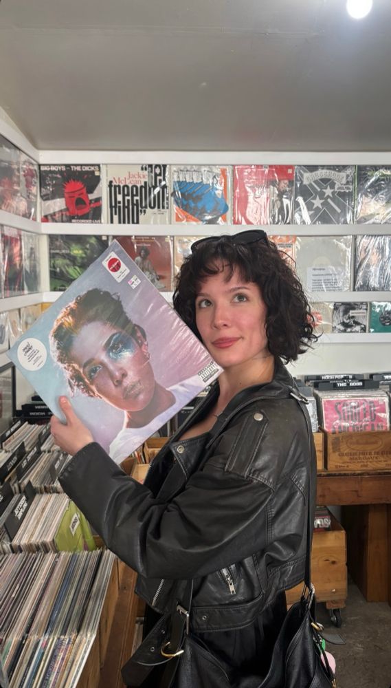 Halsey holding a vinyl copy of her album manic 