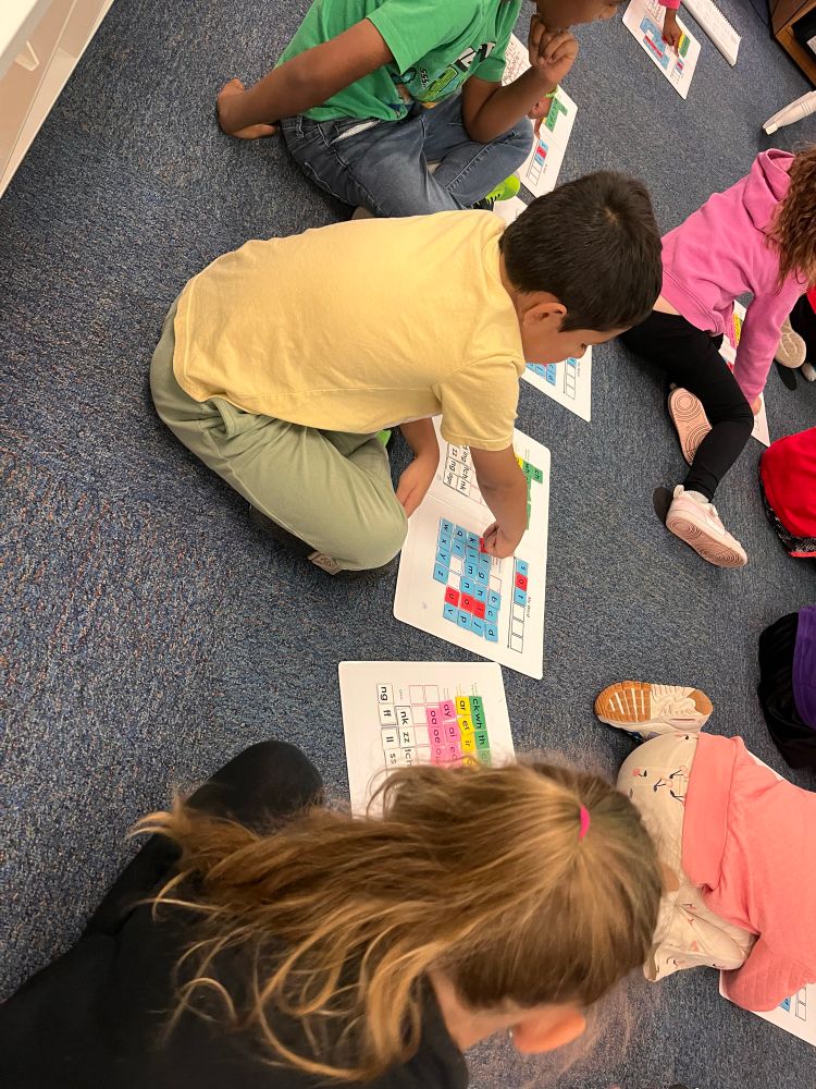 Student making words with magnetic letters 