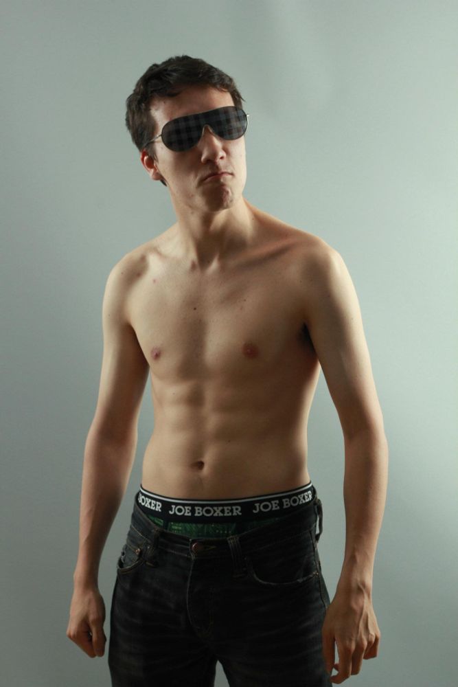 a professionally photographed shirtless picture of a much younger me flexing and looking "tough" in front of the camera with my jeans sagging, wearing glasses that have a plaid pattern for some reason