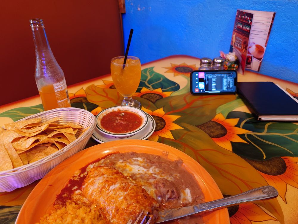 A burrito, a Jarritos, and a conference call at a Mexican restaurant.