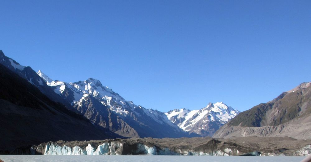 The bottom end of the Tasman Glacier with snow capped peaks in the background