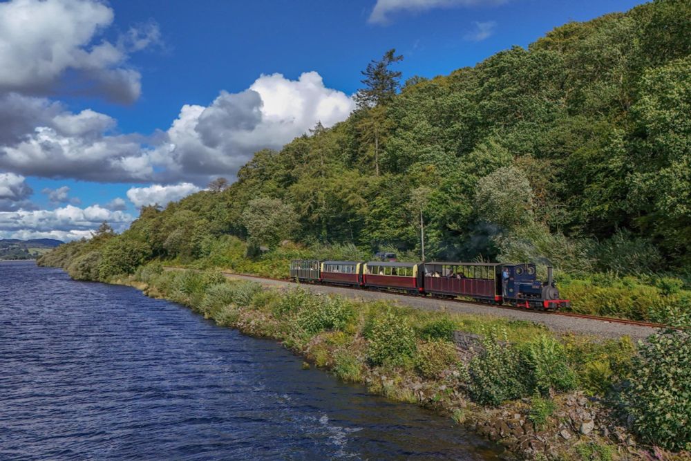 Photo of a train running alongside Llyn Tegid/Bala Lake