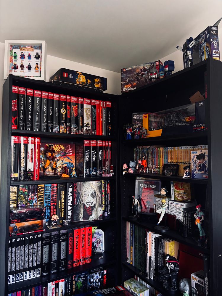 ikea billy bookcase in a corner with various marvel and dc omnibus, mangas with some merch, statues and lego around