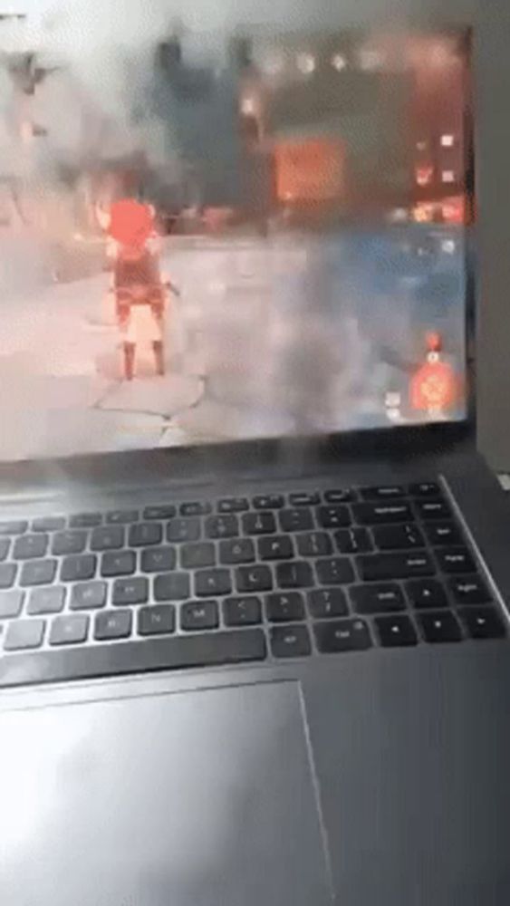 a laptop is open to a video game on the screen