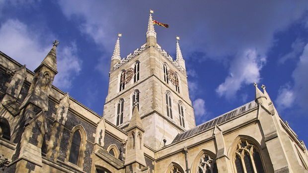 Looking up from base of Southwark Cathedral, blue sky and clouds in background