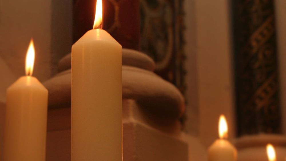 Lit candles in College Chapel, Strand