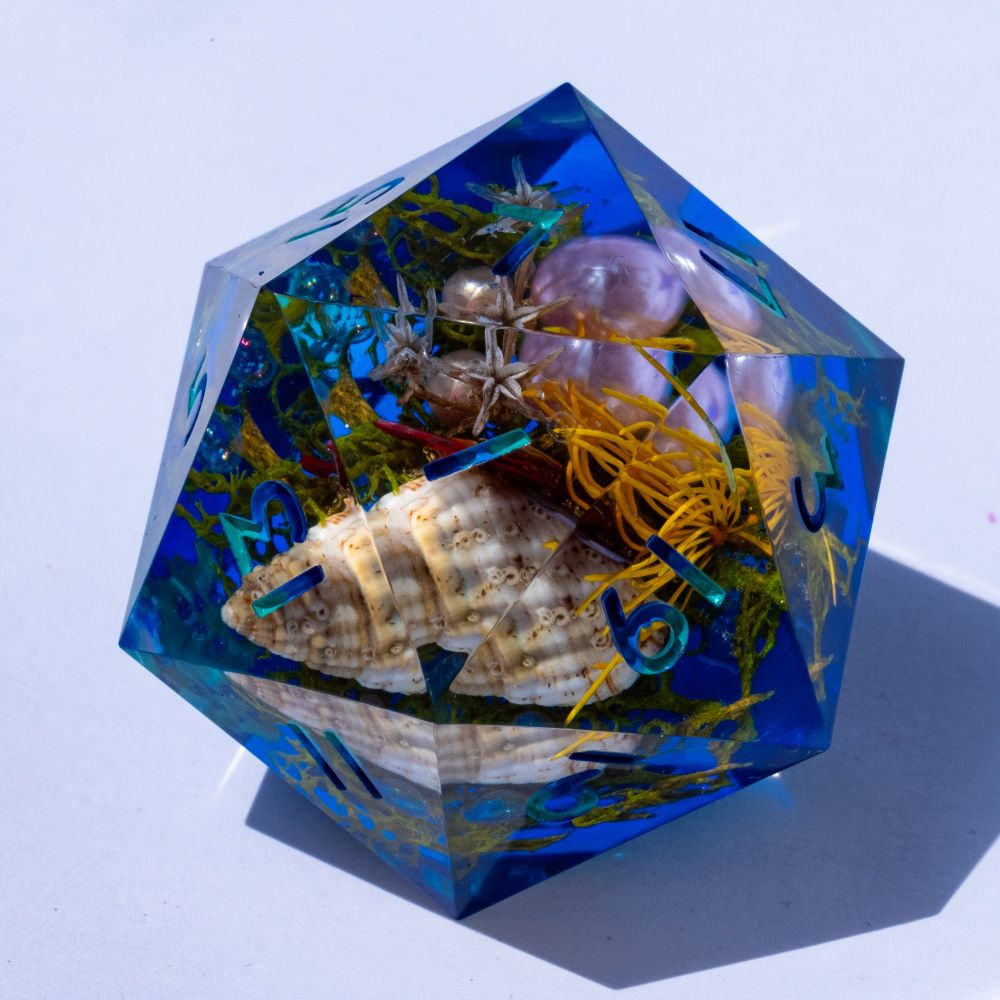 A oversized D20 with an underwater diorama on white background