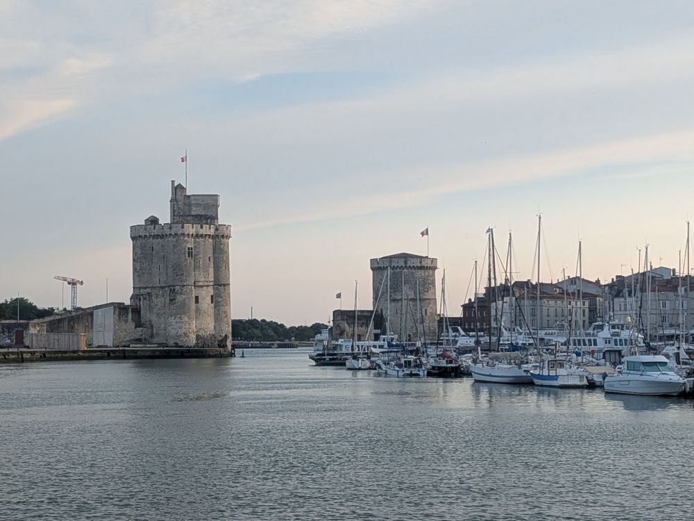 Two towers of La Rochelle in the background. Marina boats in foreground.