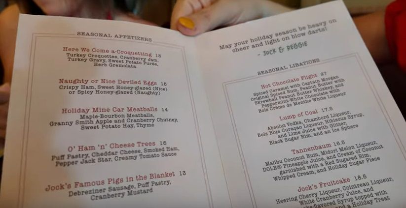 Christmas menu for Jock Lindsey's Holiday Bar, a seasonal overlay for the Walt Disney World hangar bar.

Shaped like a Christmas card, it is signed: "May your holiday season be heavy on cheer and light on blow darts! - Jock & Reggie"