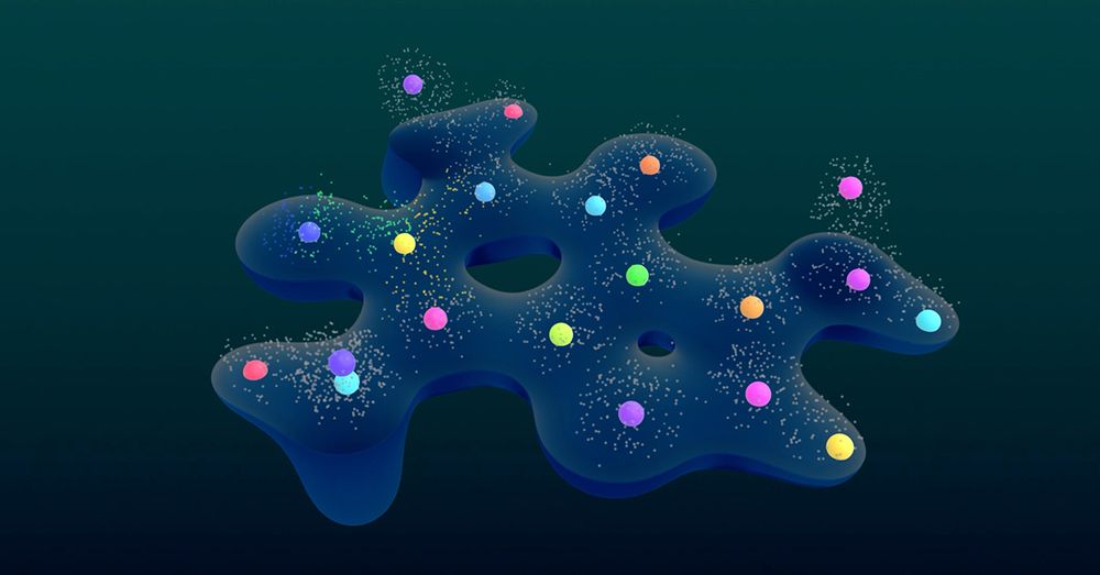 Alt Text: A dark blue, wavy surface with multiple colorful spheres placed on it. The spheres are in various colors including red, green, blue, yellow, purple, and orange. Each sphere is surrounded by small white particles that appear to be floating around them. The background is a gradient of dark teal to black.
