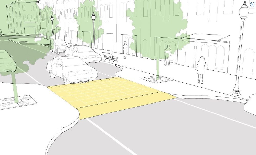 Kuva fyysisestä autoliikenteen rauhoittamisesta. Autoväylää on kavennettu ja kavennettuun kohtaan on tehty leveä hidastustöyssy. Tämä pakottaa autoilijaa hidastamaan vauhtiaan ja havainnoimaan ympäröivää liikennettä paremmin.