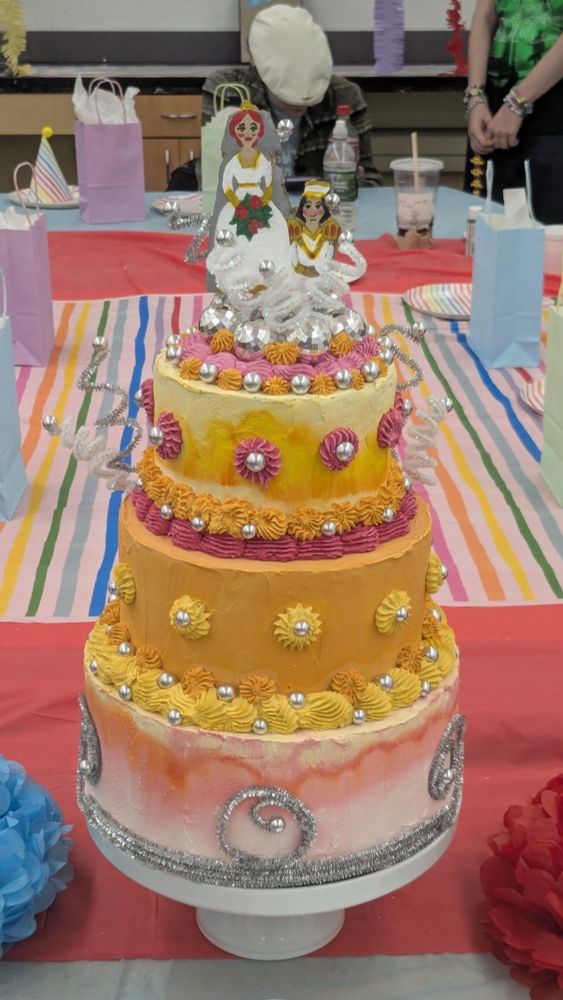 The cake topper atop a fake cake.