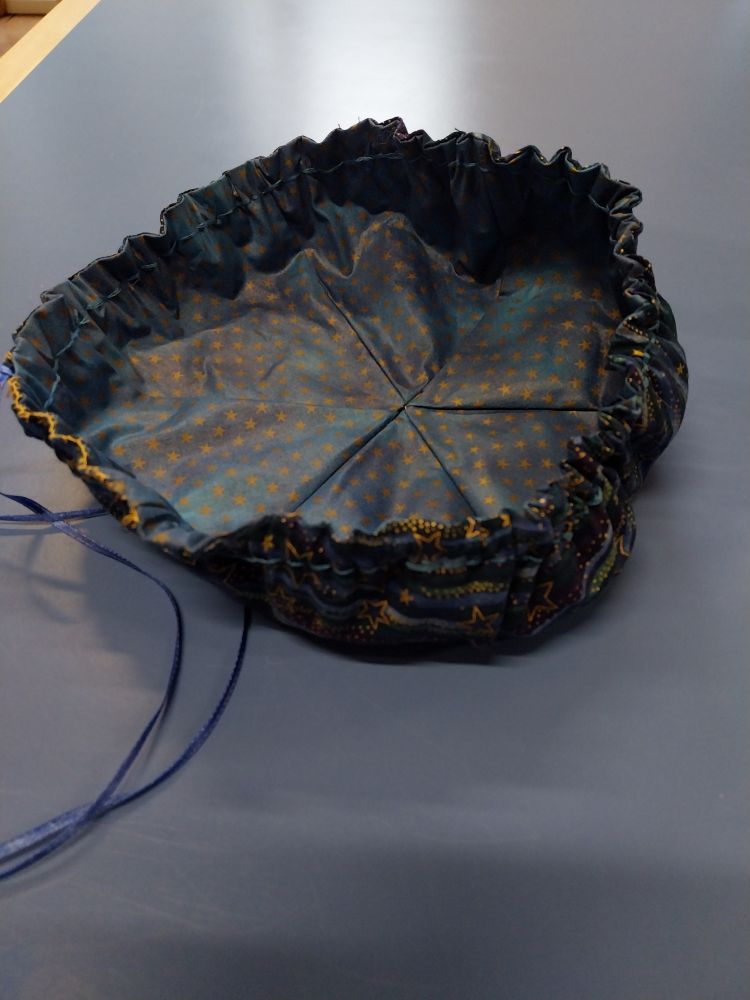 Sideview of an open drawstring bag