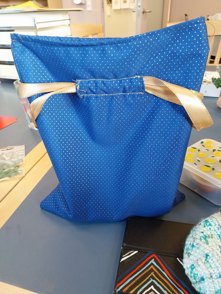 Sideview of an open drawstring bag
