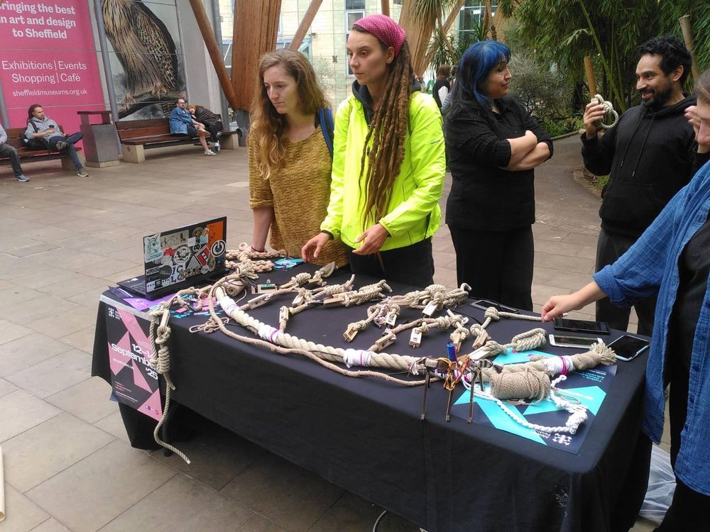 A group of people manipulating knots on a table