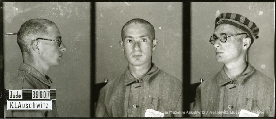 A mugshot registration photograph from Auschwitz. A man with a shaved head wearing a striped uniform photographed in three positions (profile and front with bare head and a photo with a slightly turned head with a hat on). The prisoner number is visible on a marking board on the left.