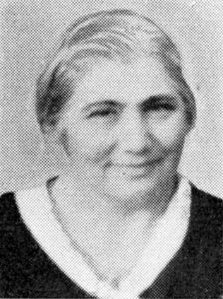 Black-and-white portrait of mature woman wearing a dark blouse with a light collar.