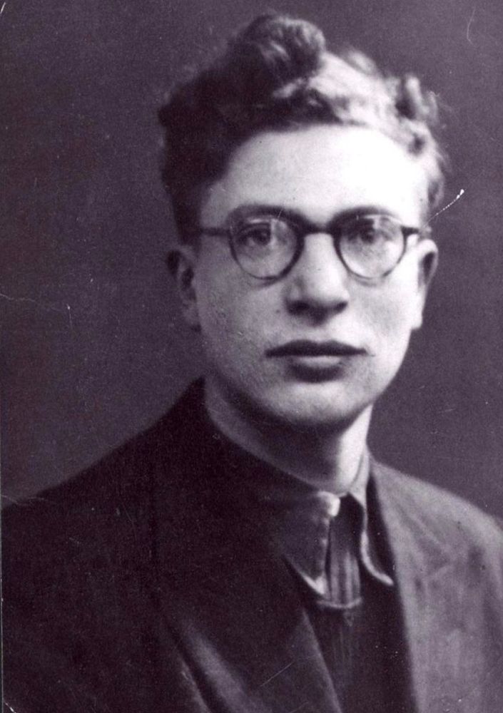 Black and white portrait of a man wearing glasses.