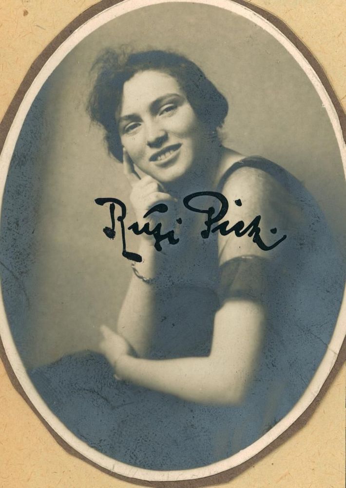 Vintage oval portrait of a smiling woman resting their head on their hand, with signature written in cursive across the image.