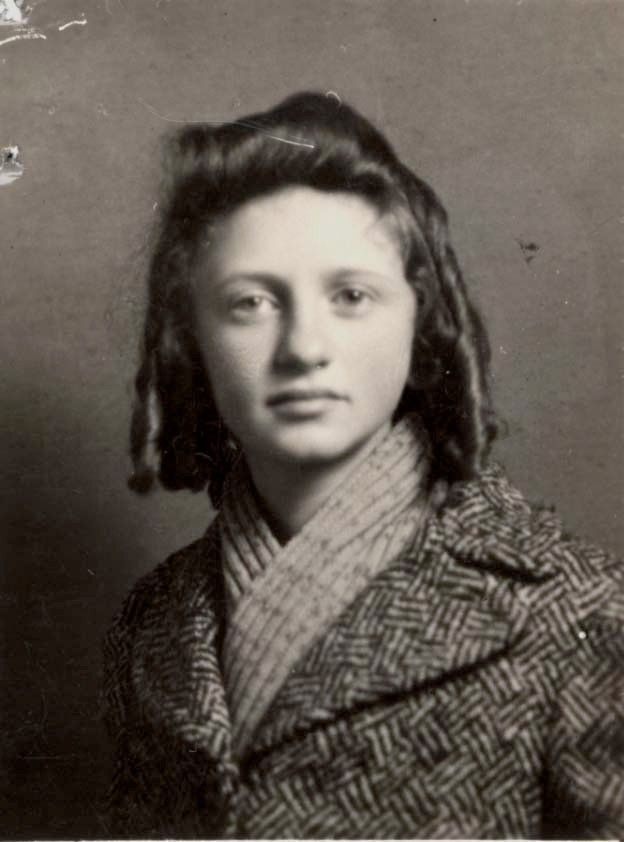 Vintage black-and-white portrait of a girl wearing a houndstooth coat. The individual has curly hair styled in two long braids.