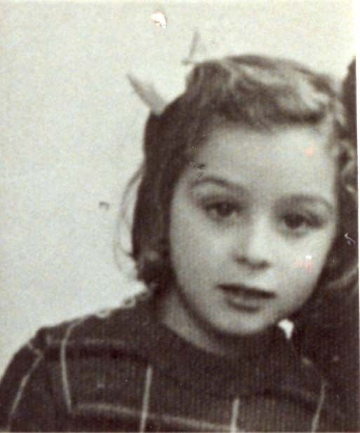 Vintage black and white photograph of a young girl with short hair, wearing a striped top