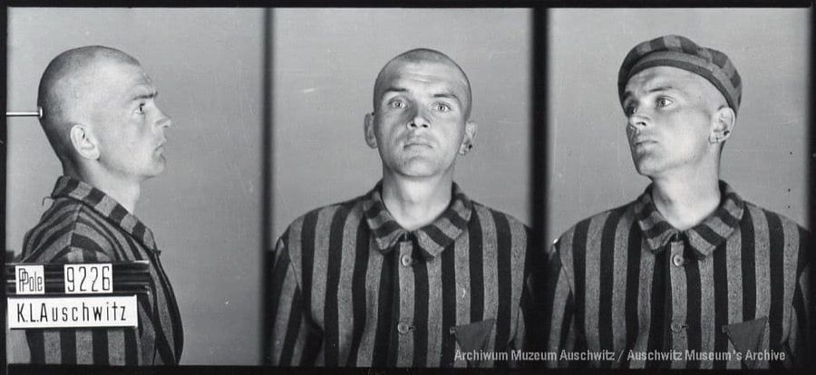 A mugshot registration photograph from Auschwitz. A man with a shaved head wearing a striped uniform photographed in three positions (profile and front with bare head and a photo with a slightly turned head with a hat on). The prisoner number is visible on a marking board on the left.
