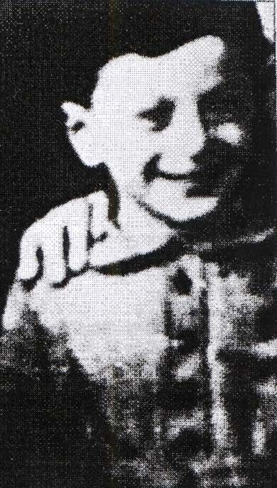 Black and white image of a smiling young boy in a casual shirt, depicted in a low-resolution or pixelated style, capturing a cheerful expression.