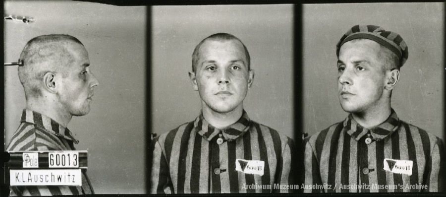 A mugshot registration photograph from Auschwitz. A man with a shaved head wearing a striped uniform photographed in three positions (profile and front with bare head and a photo with a slightly turned head with a hat on). The prisoner number is visible on a marking board on the left.