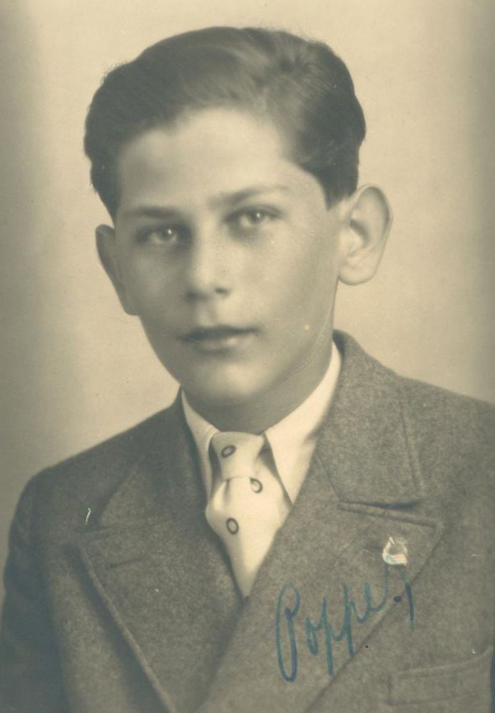 Black and white portrait of a young boy wearing a suit and tie,