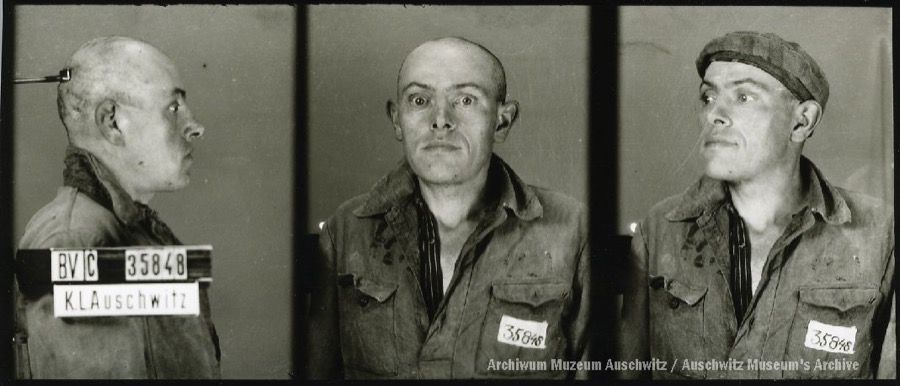 A mugshot registration photograph from Auschwitz. A man with a shaved head wearing a striped uniform photographed in three positions (profile and front with bare head and a photo with a slightly turned head with a hat on). The prisoner number is visible on a marking board on the left.