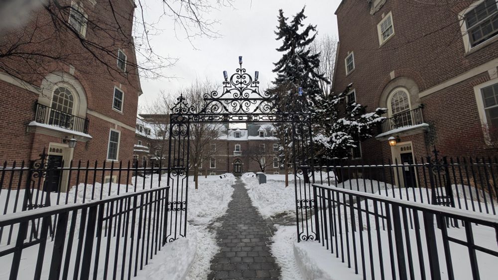 A gate into a snowy courtyard on the campus. 