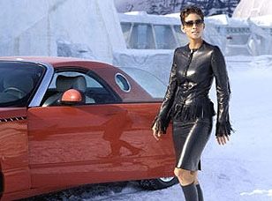 Halle Barry in a fringe leather jacket exiting a red 2002 Ford Thunderbird. 