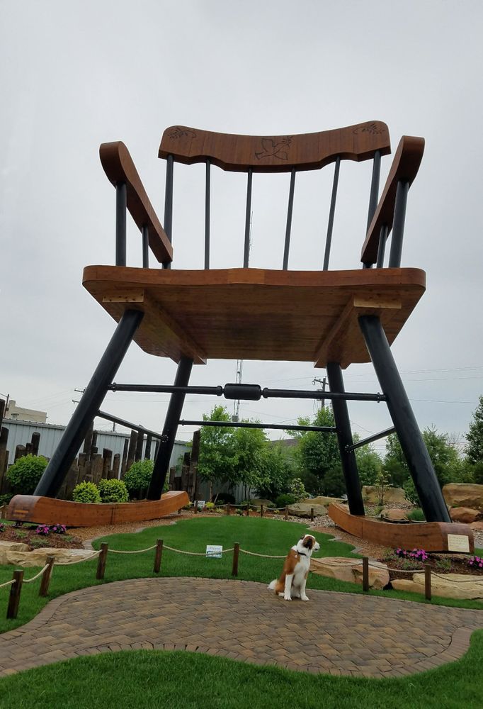 Cellphone Photo: An orange & white St. Bernard/Bernese Mountain Dog mix poses on a path under the World's Largest Rocking Chair. The chair appears to be several stories tall. She appears to be very small. But she is not. Or, rather, was not. (I miss her, of course.)
Casey, Illinois
June 2018