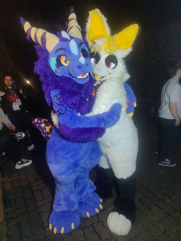 Ravas the Purple fluffy dragon hugging Fons the white bunny 
