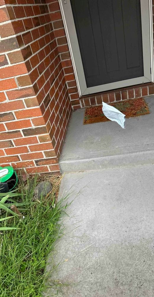 Photo showing parcel being thrown at a door