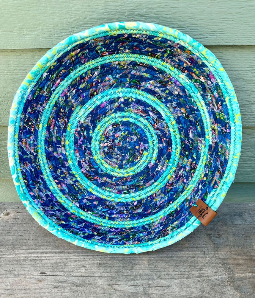 Coiled rope basket in cyan and dark blue. 