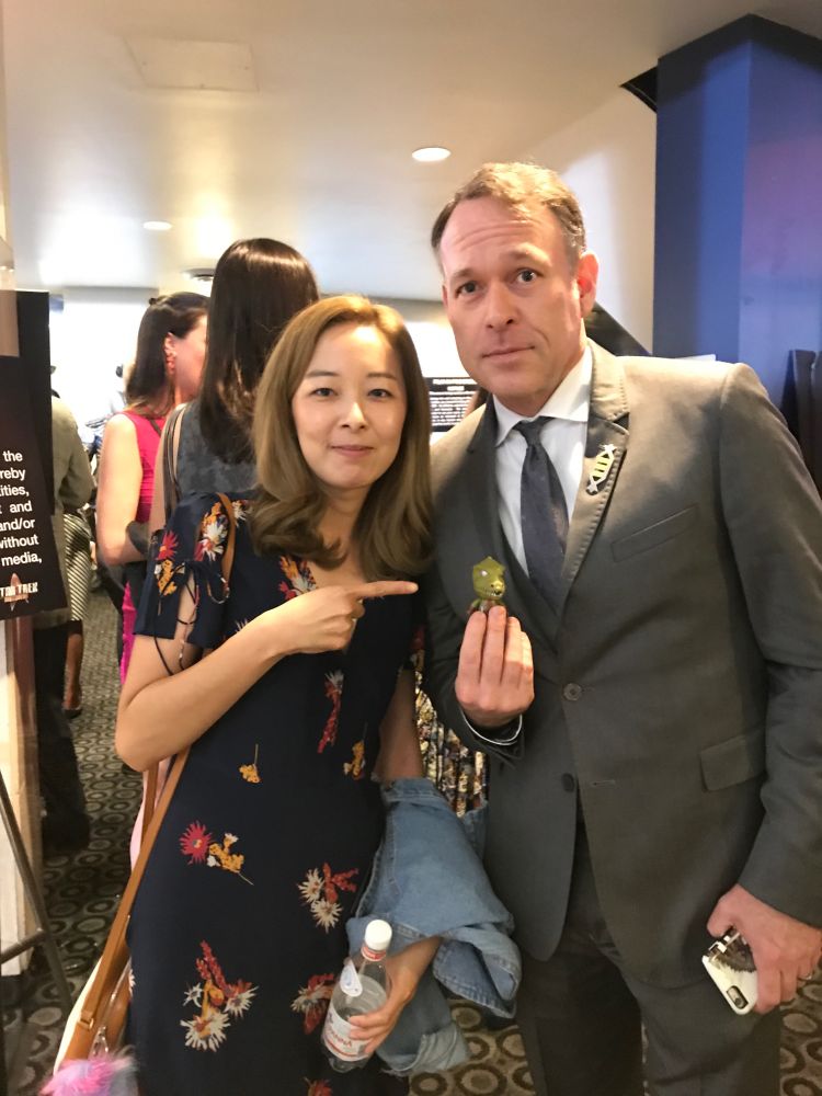 Writer Bo Yeon Kim (Boey) and Writer Ted Sullivan with Jason Gorn figure at the premiere