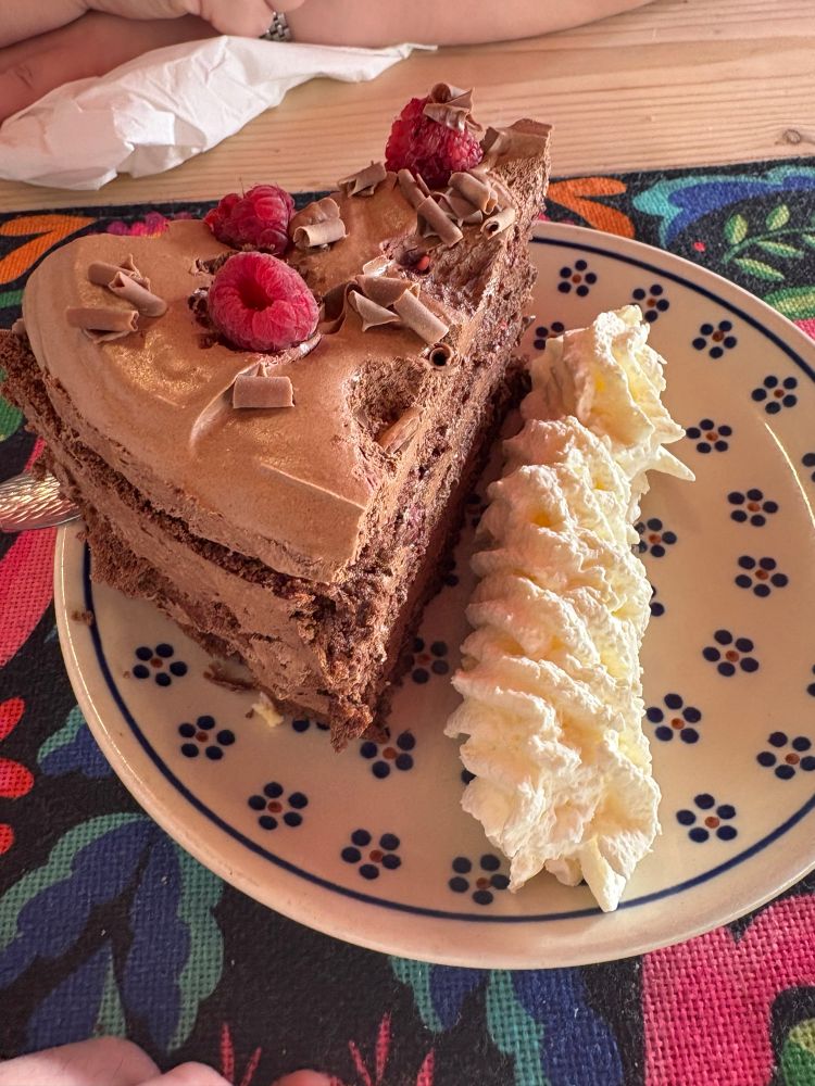 A huge piece of chocolate mousse cake with raspberries