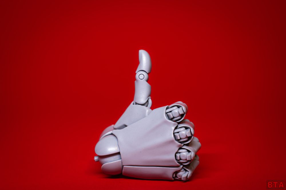 A photo of a small action figure reference hand, the hand is doing a thumbs up.