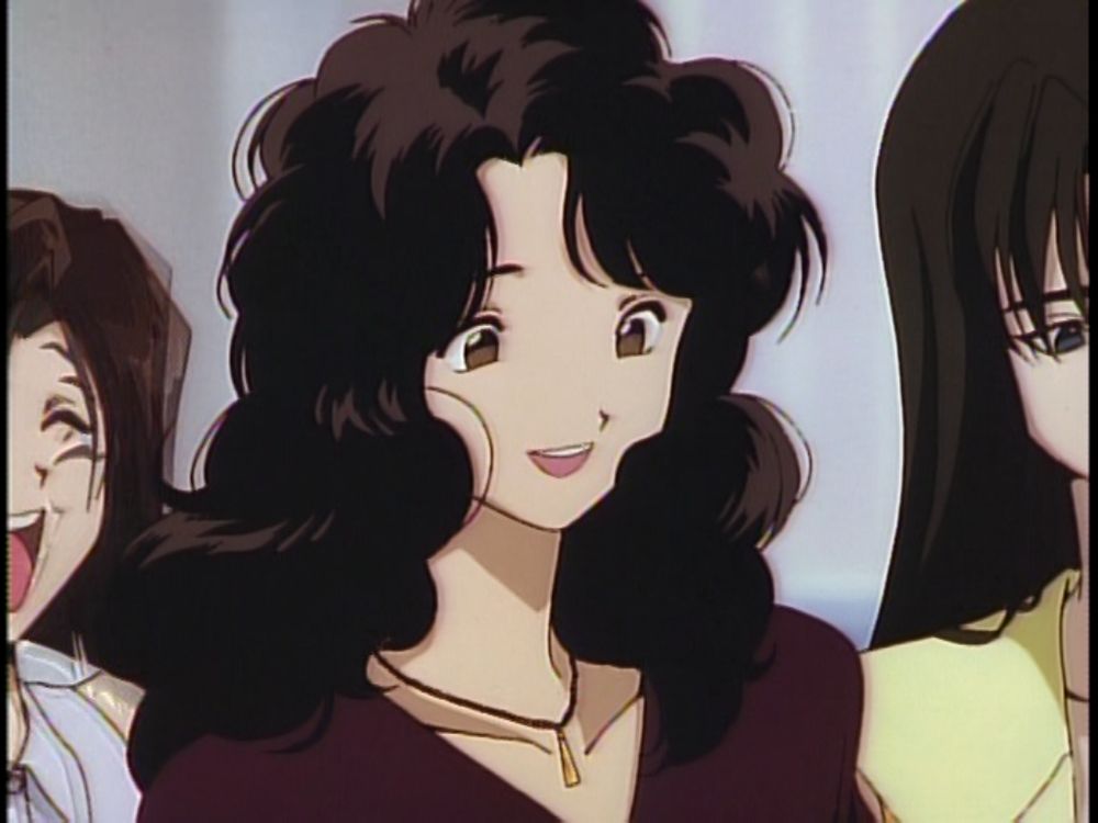 A screenshot of Golden Boy, showing a young woman in a red dress with fluffy shoulder-length hair