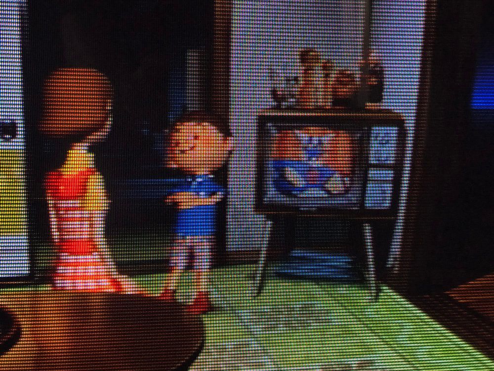 a picture of Boku no Natsuyasumi 2 (PS2) on a CRT

The game shows the titular Boku and his Aunt Mitsuko near the living room TV, showing a look-alike of Getter-1 from Getter Robo (specifically the Toei TV series from the 1970s)